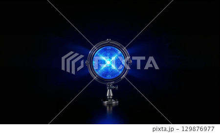 Blue lamp light shining in the dark, over black background Blue lamp light shining in the dark, over black background 129876977