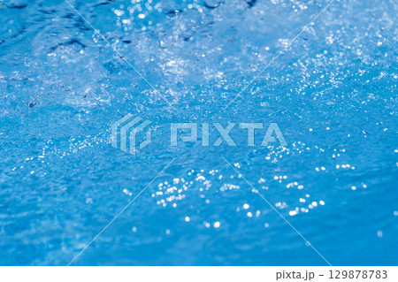 Gentle Rolling Waves and Sparkling Water Surface Under the Bright Blue Sky Above 129878783