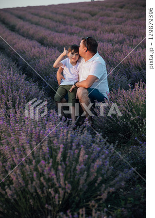 Man with son on a lavender field 129879396