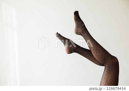Slender legs in black tights stockings 129879434