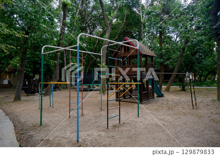Children's playground with a view of the house and slide in the park Children's playground with a view of the house and slide in the park 129879833