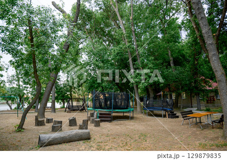 Children's playground with a view of the house and slide in the park 129879835