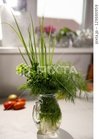 Fresh Herbs Arranged in a Glass Pitcher on a Kitchen Countertop During Daylight 129880959