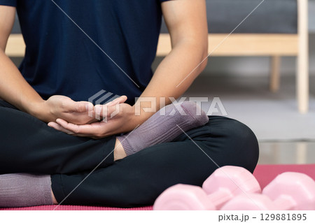 Mindfulness and Wellness. Close-up of man meditating with focus on hands. Mindfulness and Wellness. Close-up of man meditating with focus on hands. 129881895