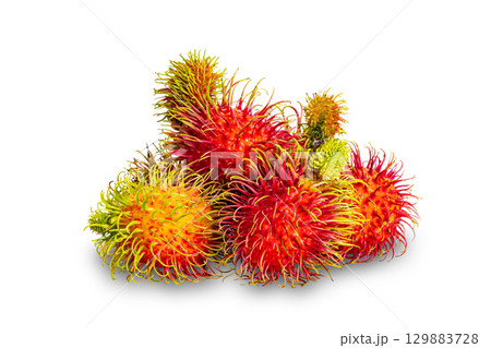 Pile of ripe rambutan fruit isolated on white background. 129883728