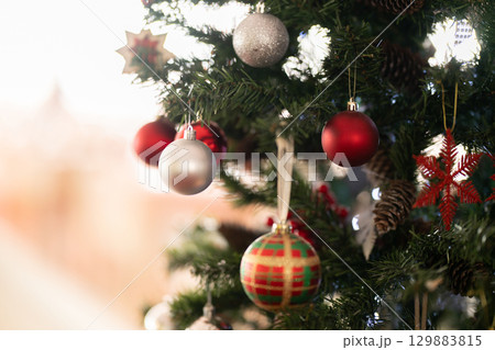 Christmas tree decorated with red and silver ornaments Christmas tree decorated with red and silver ornaments 129883815