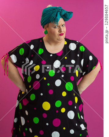 Skeptical woman posing with arms akimbo Skeptical woman posing with arms akimbo 129884657