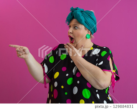 Funny woman raising hands with shocked expression Funny woman raising hands with shocked expression 129884831