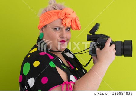 Side view of woman filming with video camera 129884833