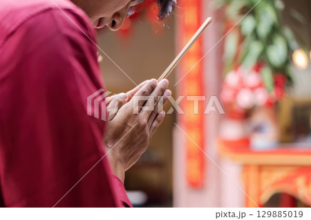 Traditional Chinese New Year Celebration with Incense and Festive Decorations in a Vibrant Cultural Setting 129885019