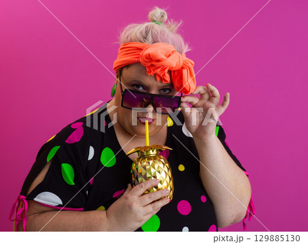 Stylish Woman with Pineapple Drink Against Pink Background 129885130