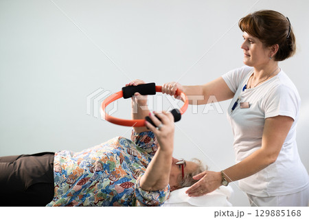 Physiotherapy Session with Elderly Woman Using Exercise Ring 129885168