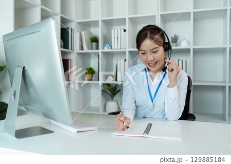 Professional Call Center Agent Working with Headset in Modern Office Environment Professional Call Center Agent Working with Headset in Modern Office Environment 129885184