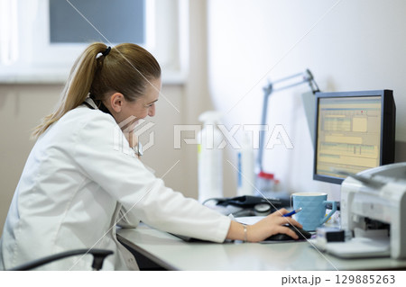 Female doctor working on computer in clinic Female doctor working on computer in clinic 129885263