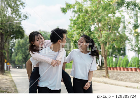 Happy Family Enjoying Outdoor Walk Embracing Wellness and Togetherness in a Natural Setting Happy Family Enjoying Outdoor Walk Embracing Wellness and Togetherness in a Natural Setting 129885724