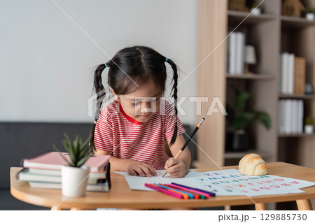 Child Learning with Parent at Home - Educational and Family Bonding Concept in a Cozy Environment Child Learning with Parent at Home - Educational and Family Bonding Concept in a Cozy Environment 129885730