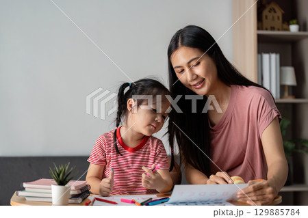 Parent and Child Engaged in Learning Activity at Home, Fostering Education and Bonding Through Creative and Interactive Playtime 129885784