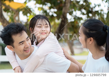 Happy Family Enjoying Outdoor Wellness Activities Together in a Park Setting Happy Family Enjoying Outdoor Wellness Activities Together in a Park Setting 129885799
