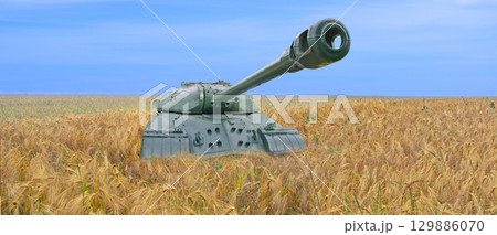 Old tank on the field of yellow wheat and blue sky. The concept of war in Ukraine 129886070