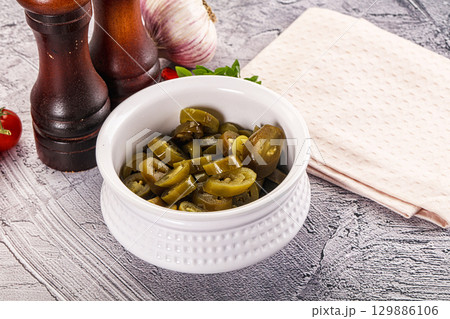 Sliced pickled jalapeno spicy pepper 129886106