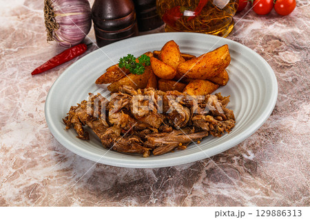 Baked shredded pork with potato 129886313