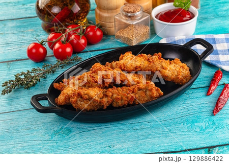 Golden crispy fried chicken strips Golden crispy fried chicken strips 129886422