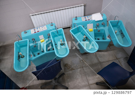 Hydrotherapy Machines in Spa Clinic.Modern hydrotherapy equipment in a clinical setting, used for hand and foot therapy treatments in rehabilitation centers. Hydrotherapy Machines in Spa Clinic.Modern hydrotherapy equipment in a clinical setting, used for hand and foot therapy treatments in rehabilitation centers. 129886797