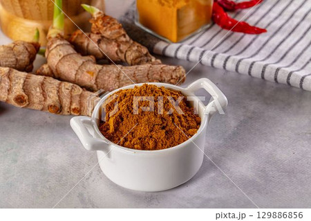 Indian spices - Curry powder heap 129886856