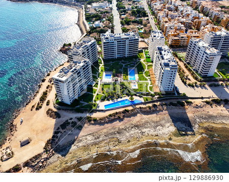 Aerial view of Punta Prima coastline. Spain 129886930