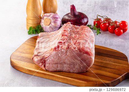 Raw pork loin with bone 129886972