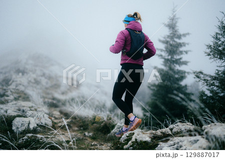 Trail Runner in Misty Mountain Landscape 129887017