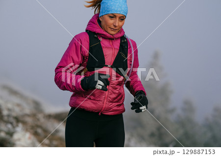 Trail Runner in Misty Mountain Landscape 129887153