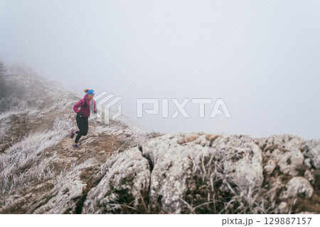 Trail Runner in Misty Mountain Landscape 129887157