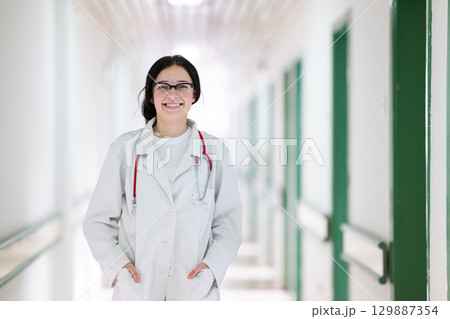 Doctor smiling in hospital hallway 129887354
