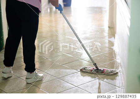 Cleaning Staff in Hospital Hallway.Female janitor standing in a hospital corridor with mop and bucket, symbolizing cleanliness and hygiene. Cleaning Staff in Hospital Hallway.Female janitor standing in a hospital corridor with mop and bucket, symbolizing cleanliness and hygiene. 129887435
