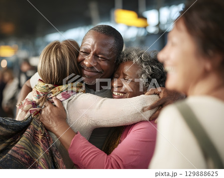cheerful family reunion at airport arrival hall warm hugs and smiles cheerful family reunion at airport arrival hall warm hugs and smiles 129888625