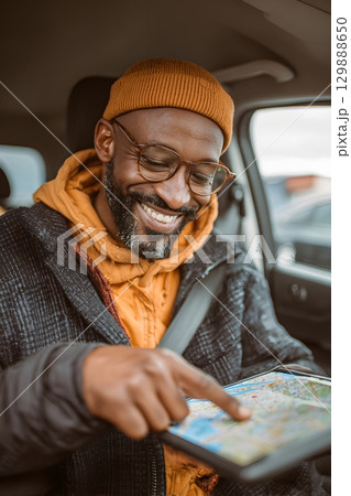 traveler adjusting GPS in car after airport pickup 129888650