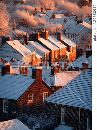 snow covered village rooftops at sunrise 129888936