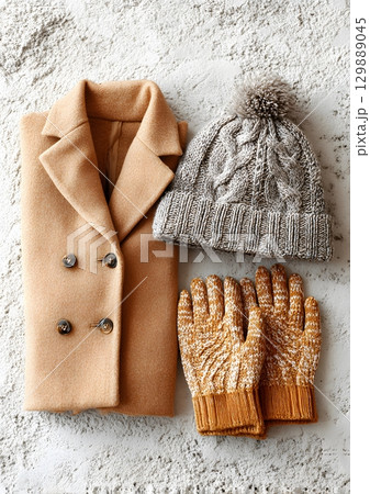 winter fashion flat lay with hat gloves and coat 129889045