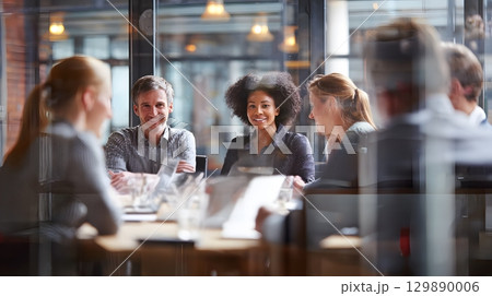 collaborative business team of men and women working together in meeting room front view 129890006