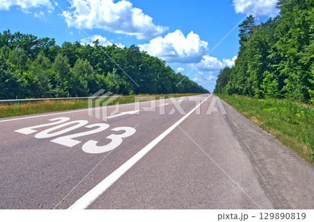 Road with the inscription 2023 and forward arrows. concept of achieving goals in the New Year 2023 Road with the inscription 2023 and forward arrows. concept of achieving goals in the New Year 2023 129890819