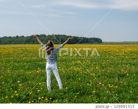 happy woman, with her arms spread wide 129891315