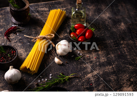 Italian food background with spaghetti, tomato and spices 129891593