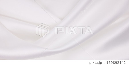 Smooth elegant white silk or satin luxury cloth texture as wedding background. Luxurious background design Smooth elegant white silk or satin luxury cloth texture as wedding background. Luxurious background design 129892142
