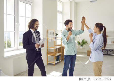 Happy family couple having fun after making deal with real estate and buying new house or apartment Happy family couple having fun after making deal with real estate and buying new house or apartment 129892205