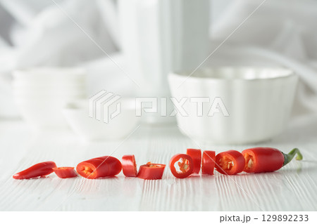 Fresh red chili pepper on a white wooden table. 129892233