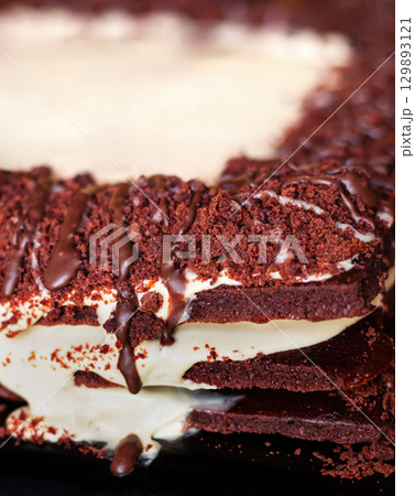Festive layered chocolate cake with milk cream, dark chocolate cake 129893121