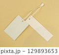 Two white empty labels on a beige background. Tags for prices or product names. 129893653