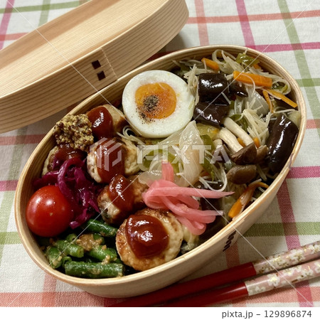 A traditional Korean dosirak, beautifully arranged with rice, assorted banchan, and savory proteins. Balanced and visually inviting, its a portable meal packed with vibrant flavors. A traditional Korean dosirak, beautifully arranged with rice, assorted banchan, and savory proteins. Balanced and visually inviting, its a portable meal packed with vibrant flavors. 129896874