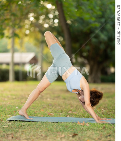 Adult woman doing yoga in park 129897628
